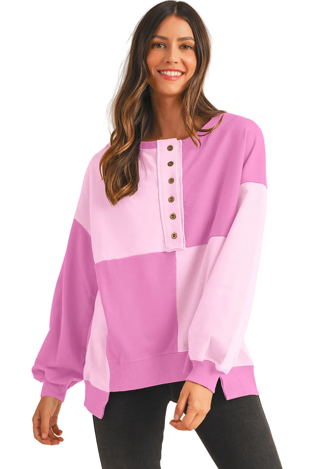 Woman wearing a pink and purple color-blocked top with buttons on a white background