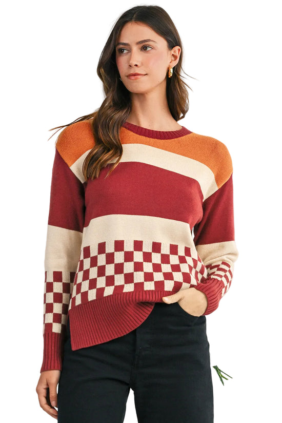 Woman wearing a colorful sweater with a checkered pattern on a white background