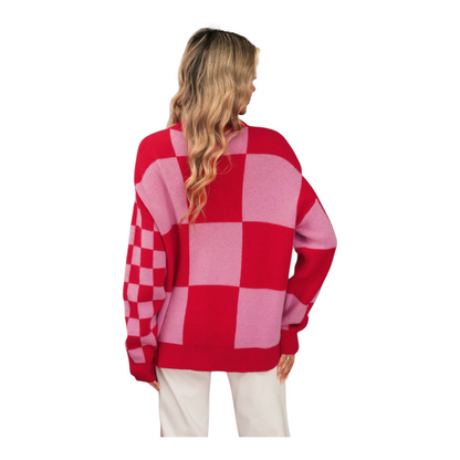 Person wearing a red and pink checkered sweater on a white background