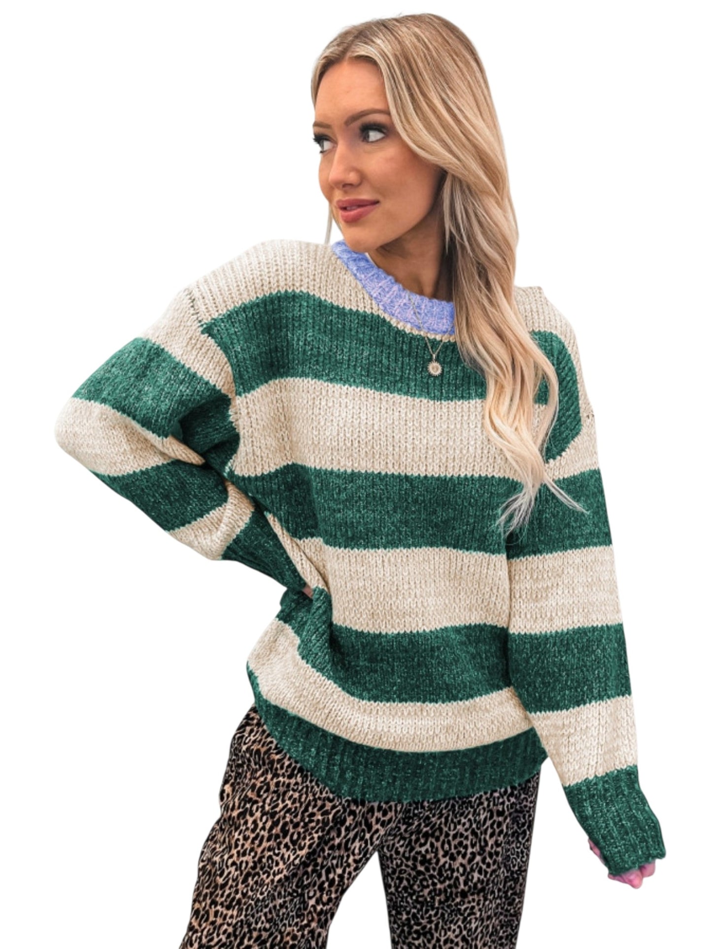 A woman wearing a chunky knit sweater with horizontal green and cream stripes, paired with leopard print pants, against a plain white background.