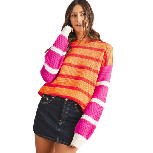 Woman wearing a colorful striped sweater on a white background