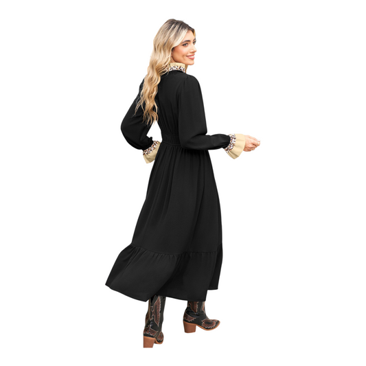 Woman wearing a black dress with long sleeves on a white background