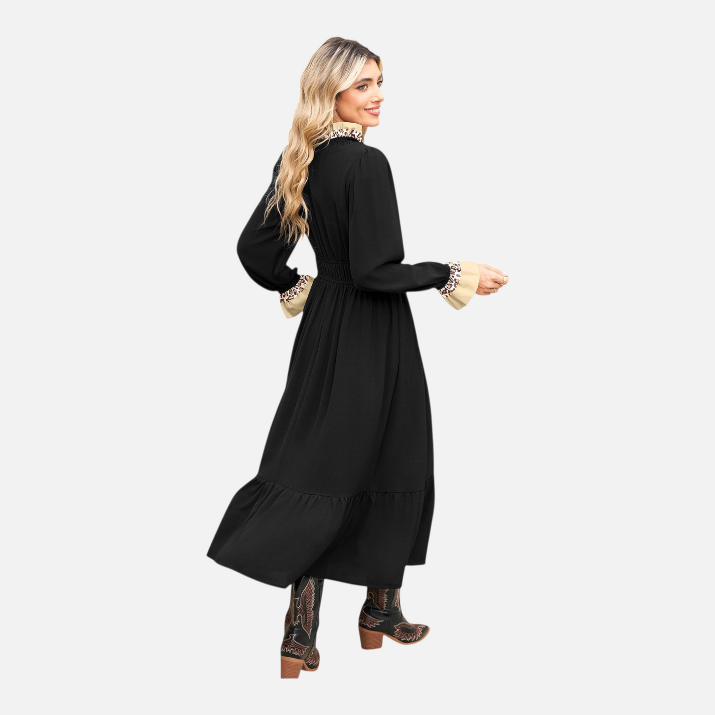 Model seen from the back wearing a long-sleeve black midi dress with animal print trim at the cuffs, featuring a shirred waist and tiered skirt.