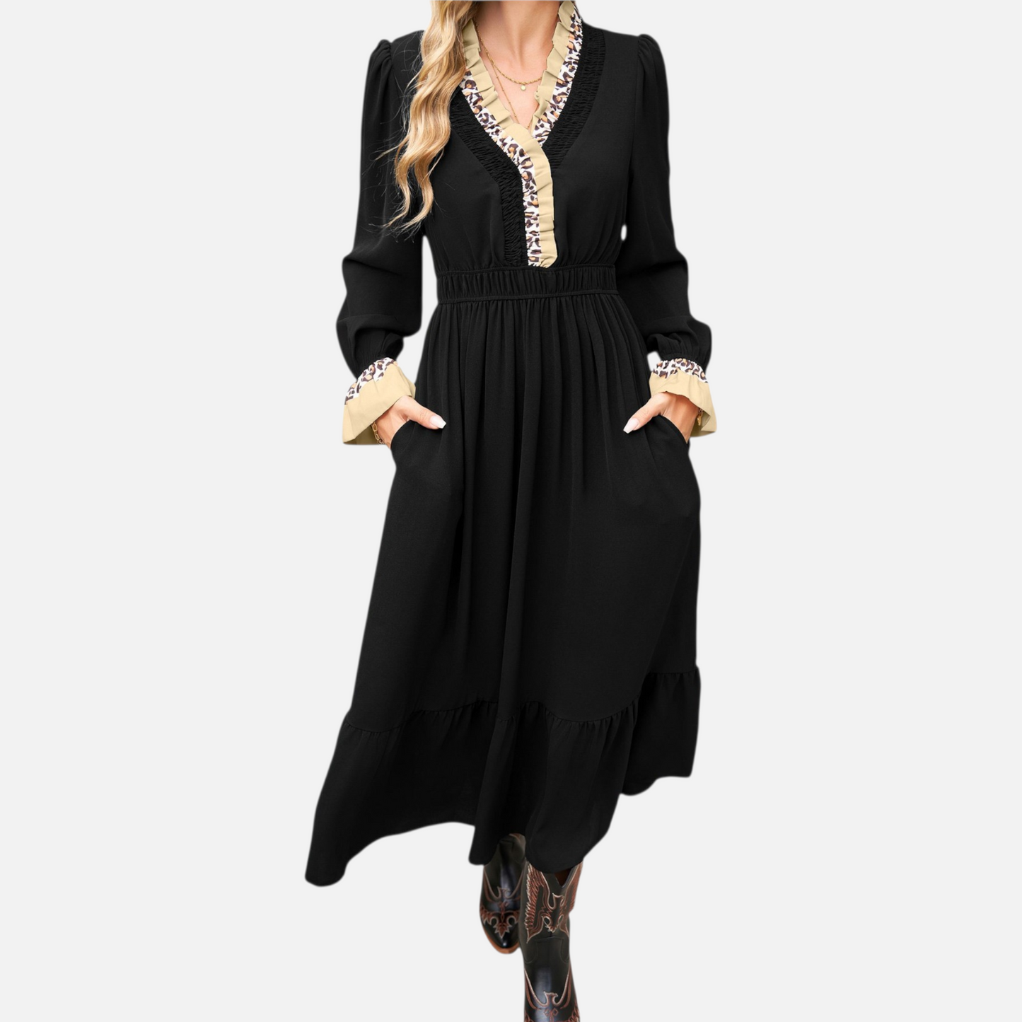 Studio shot of a model wearing a black long-sleeve midi dress with animal print trim on the collar and cuffs.