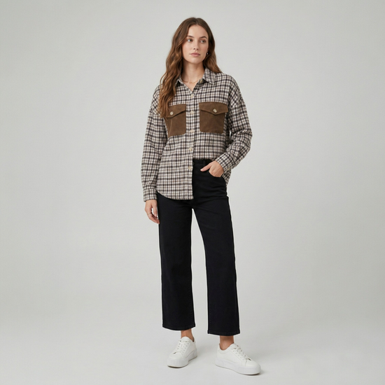 Front view of a model in a textured brown, tan, and beige patchwork shacket with a relaxed fit.