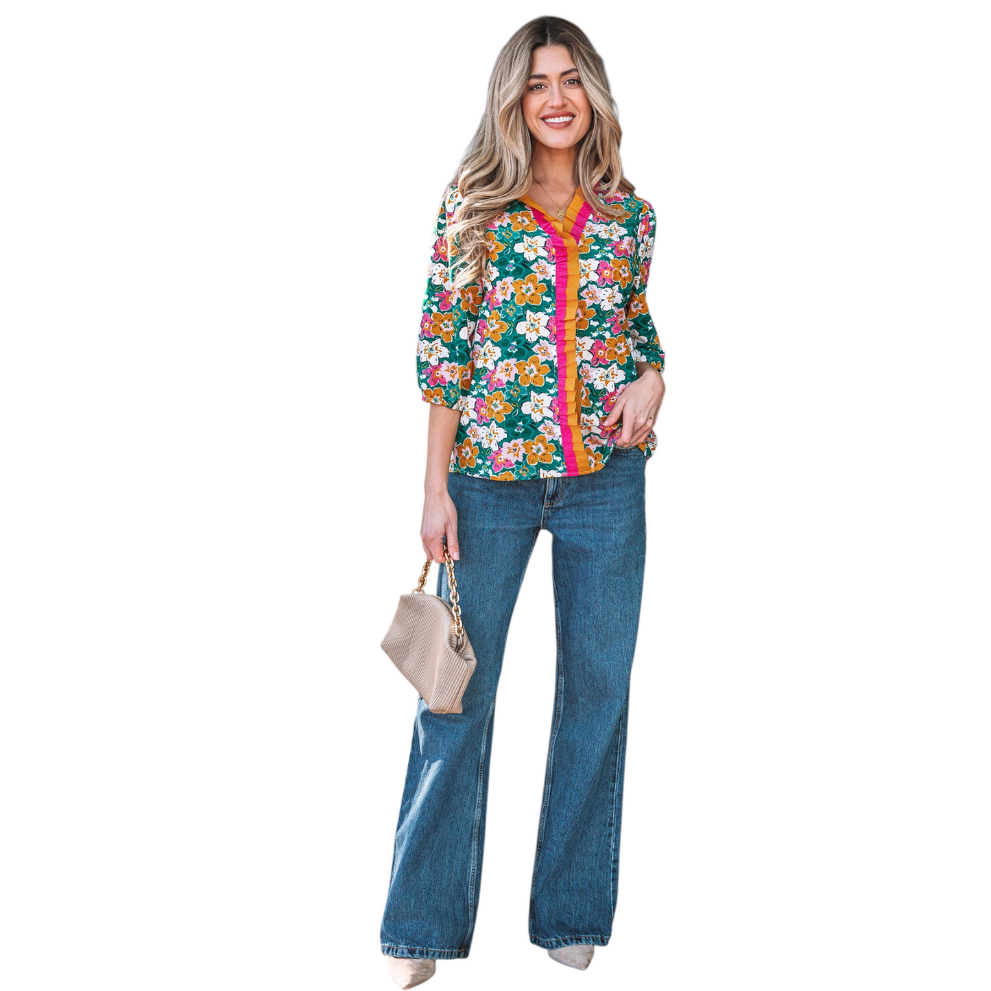 A woman wearing an emerald green floral V-neck blouse featuring distinctive magenta and ochre contrast frilled trim along the neckline and 3/4 length sleeves.