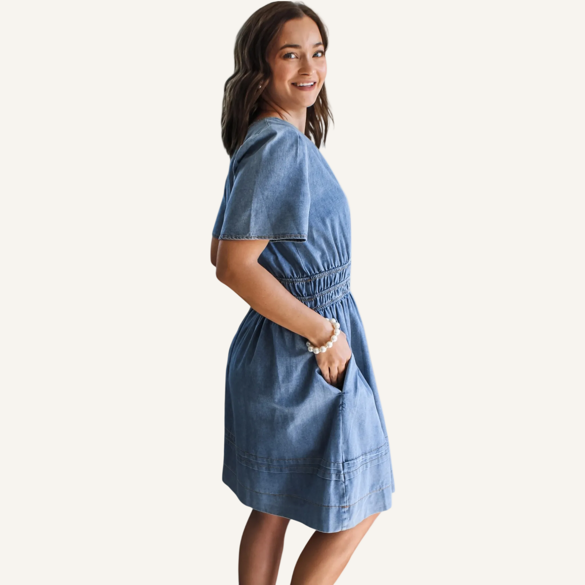 Woman wearing a blue dress on a neutral background