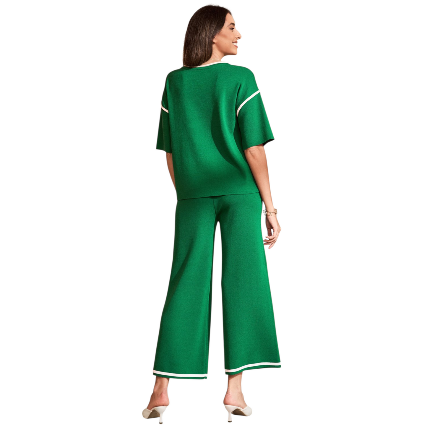 Back view of a premium green knitted sweater suit showing the relaxed silhouette and contrast piping detail on the shoulders and leg hems.