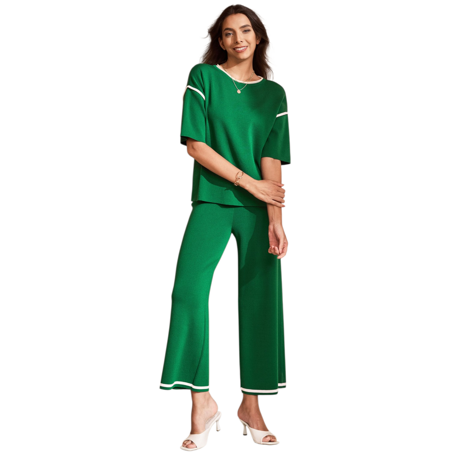 A woman wearing a green two-piece knit loungewear set featuring a half-sleeve top with contrast trim and matching high-waisted wide-leg pants.