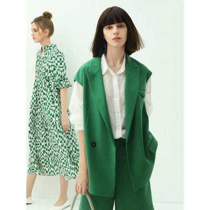 Two women wearing green and white outfits on a white background