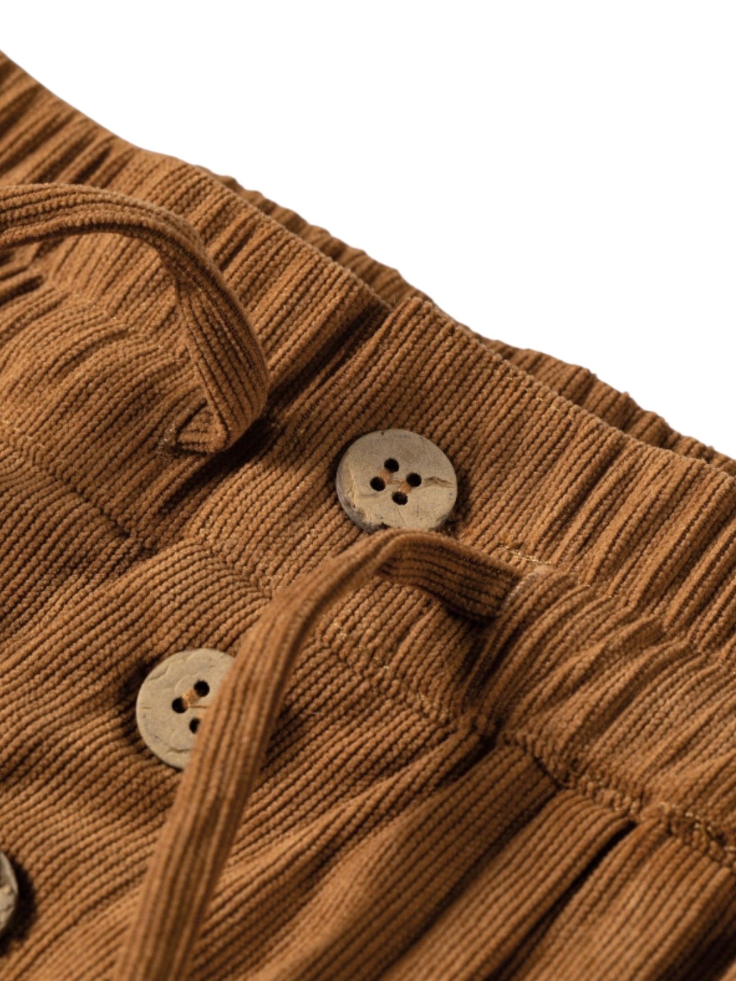 Close-up of a brown ribbed corduroy garment with a pleated waistband and light beige buttons on a white background.