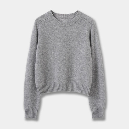 Front flat lay view of a grey marle crew neck wool-blend sweater on a solid grey background.