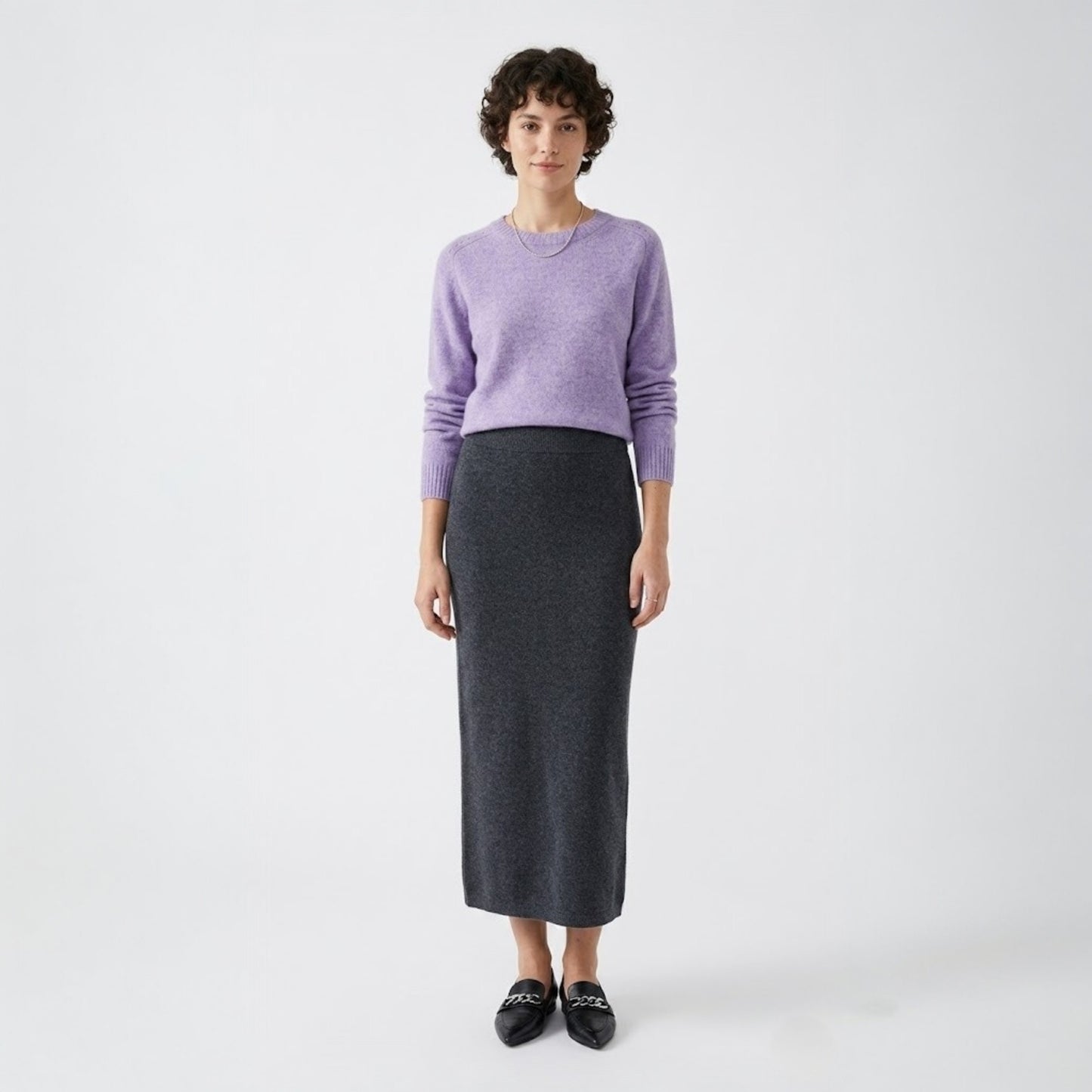 Model styling the light purple wool-blend sweater with a charcoal midi skirt and black loafers.