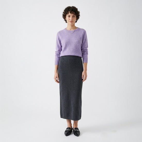 Model styling the light purple wool-blend sweater with a charcoal midi skirt and black loafers.