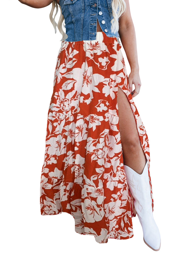 Woman wearing a red floral dress with a denim jacket on a white background