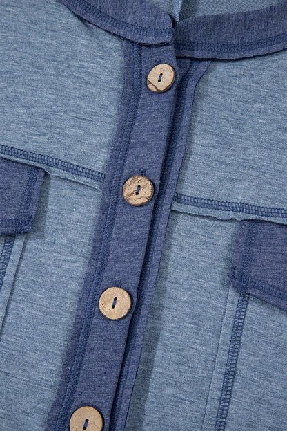 Close-up of a blue garment with wooden buttons
