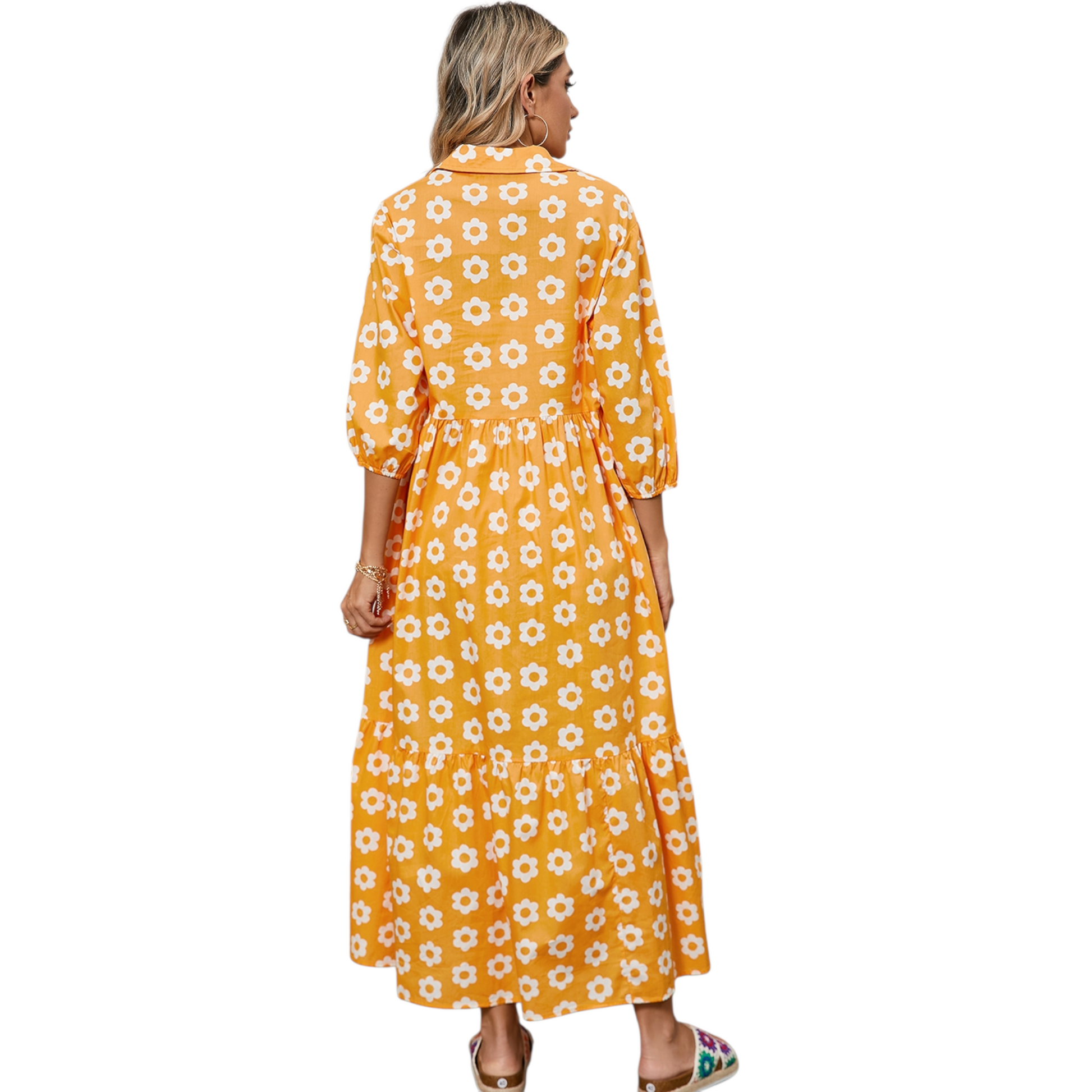 Back view of a woman wearing a yellow and white daisy print maxi dress with a collared neckline and button-down front.
