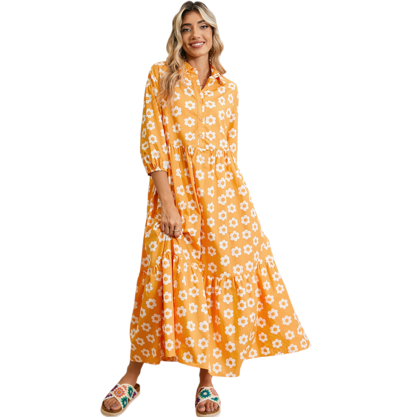 Woman wearing a yellow and white daisy print maxi dress with a collared neckline and button-down front.
