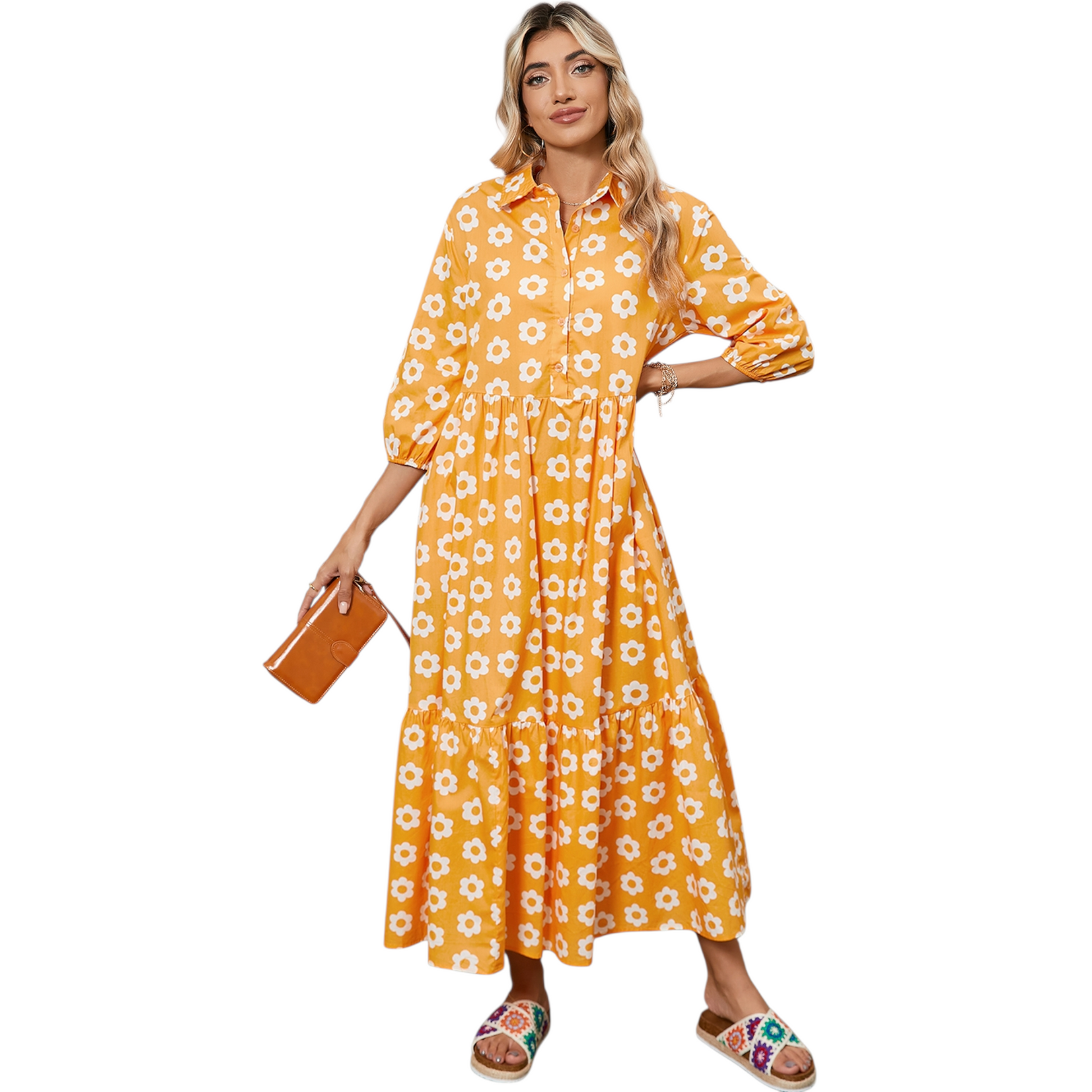 Woman wearing a yellow and white daisy print maxi dress with a collared neckline and button-down front.