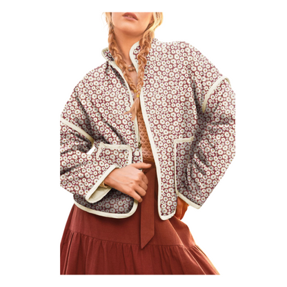 A woman wearing a burgundy quilted jacket with a white daisy floral print, featuring a stand collar and relaxed fit.