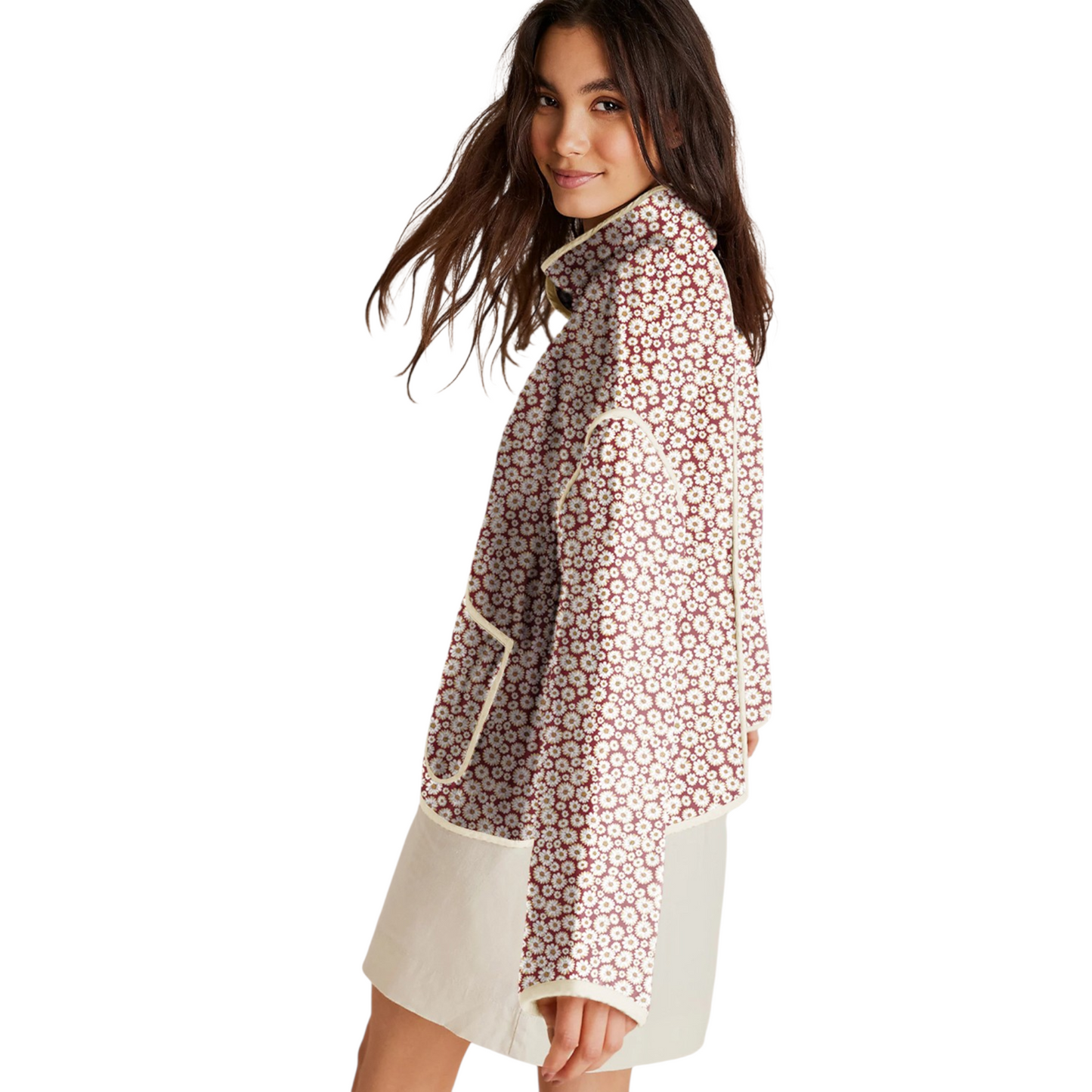 A woman wearing a burgundy quilted jacket with a white daisy floral print, featuring a stand collar and relaxed fit.