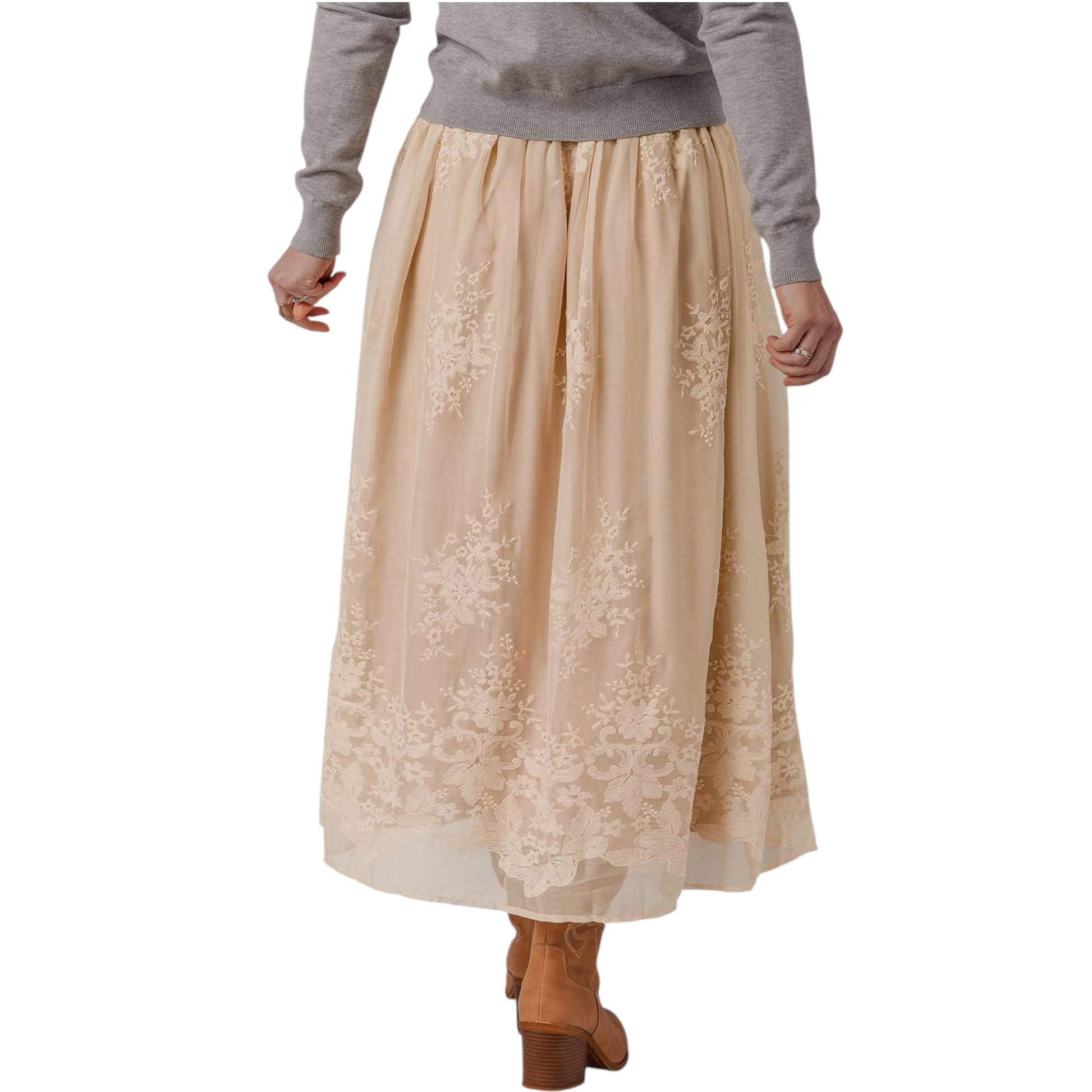 Beige lace skirt worn with a gray sweater on a white background