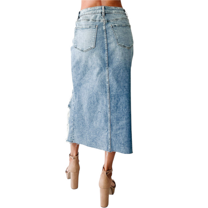 Denim skirt worn by a person on a white background
