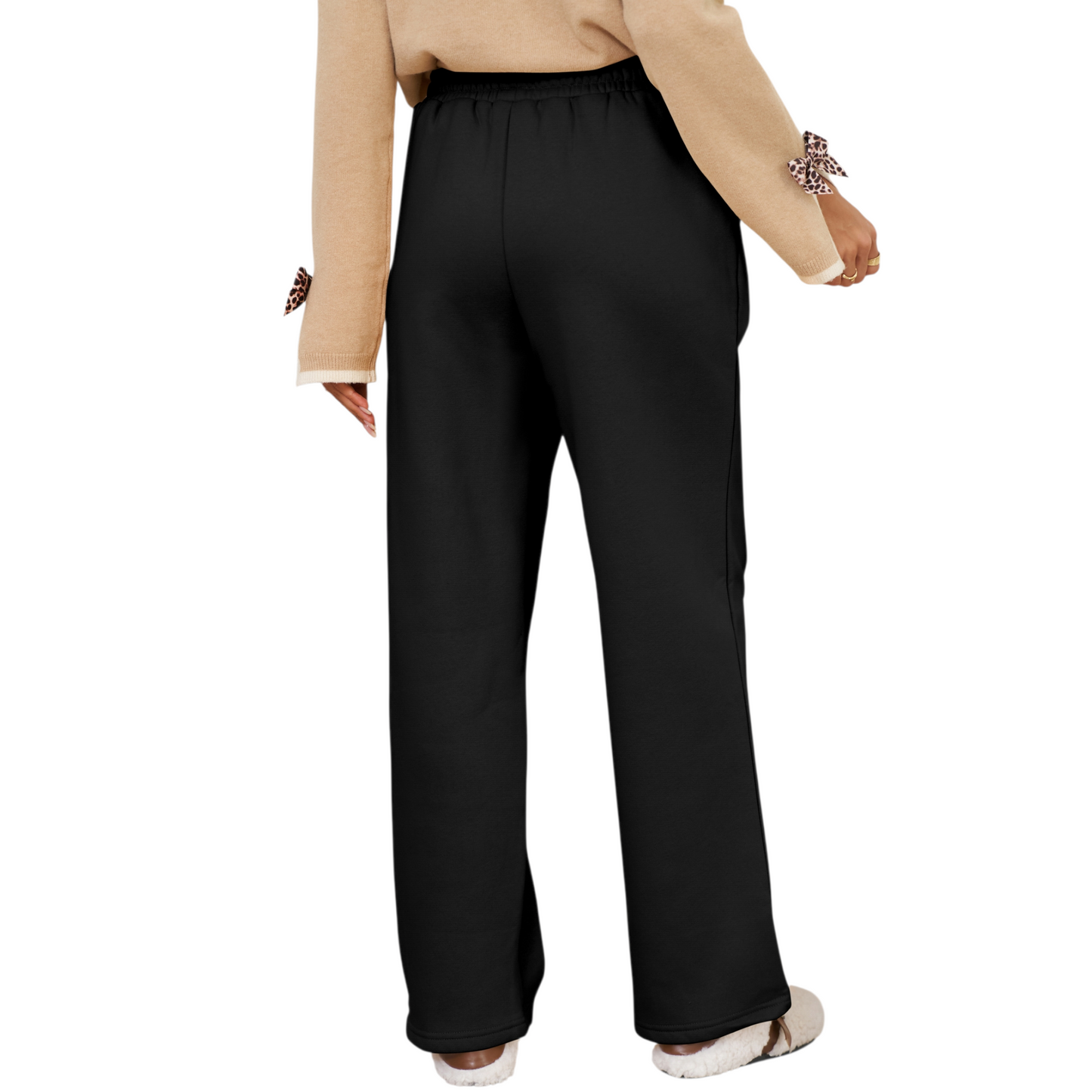 Person wearing black pants on a white background