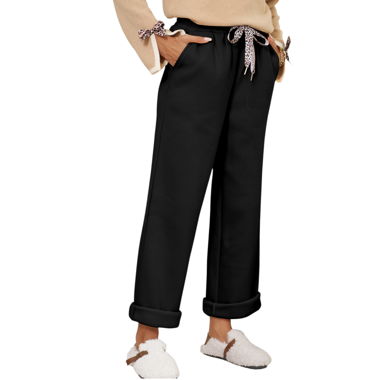 Person wearing black pants with a white background