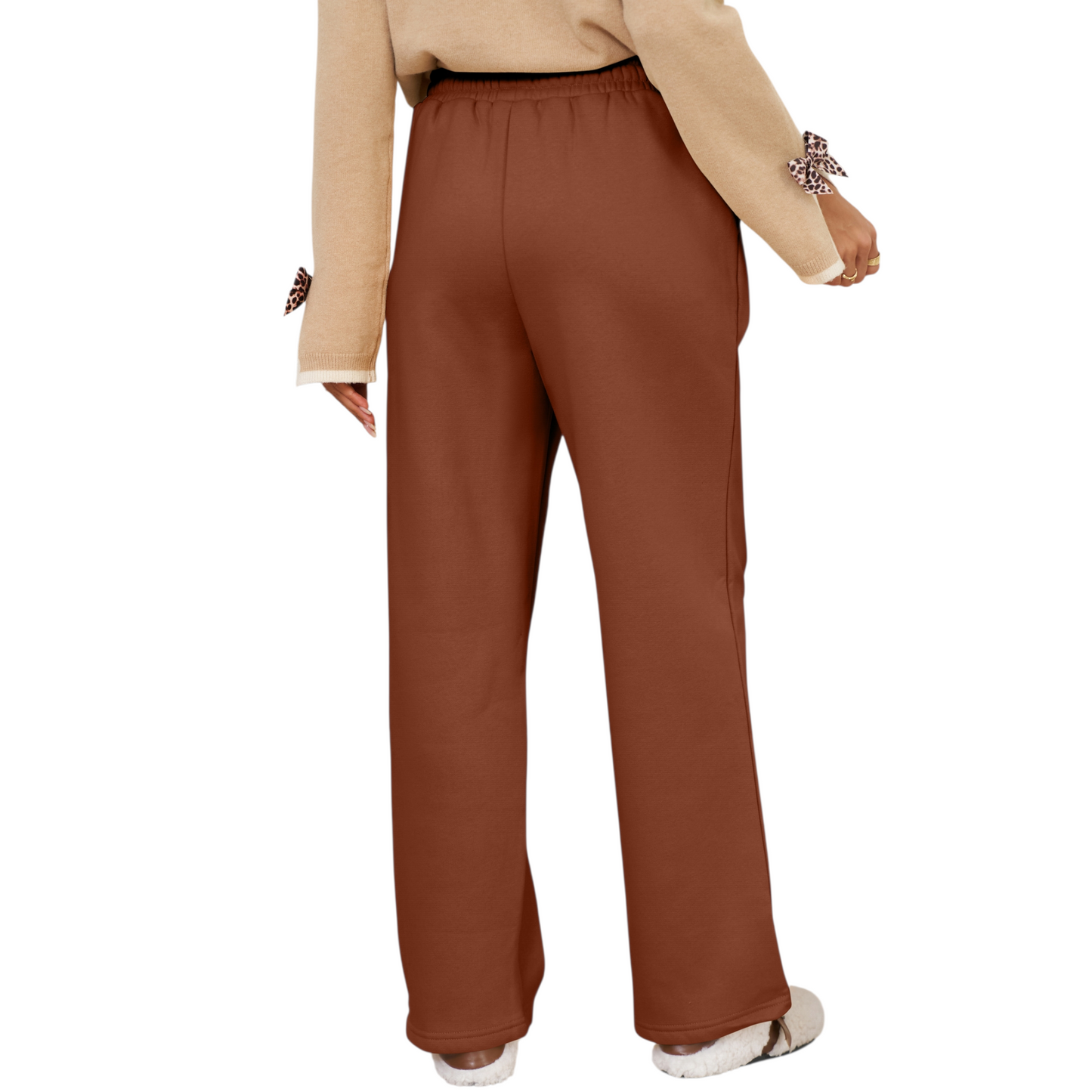 Brown pants worn by a person on a white background