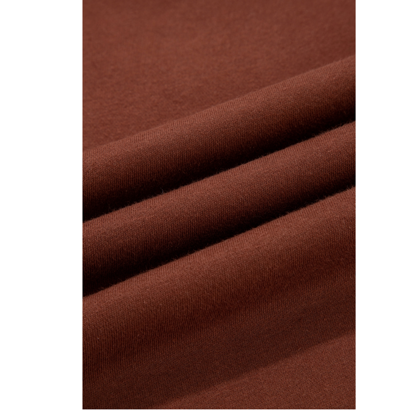 Close-up of brown fabric with folds on a white background