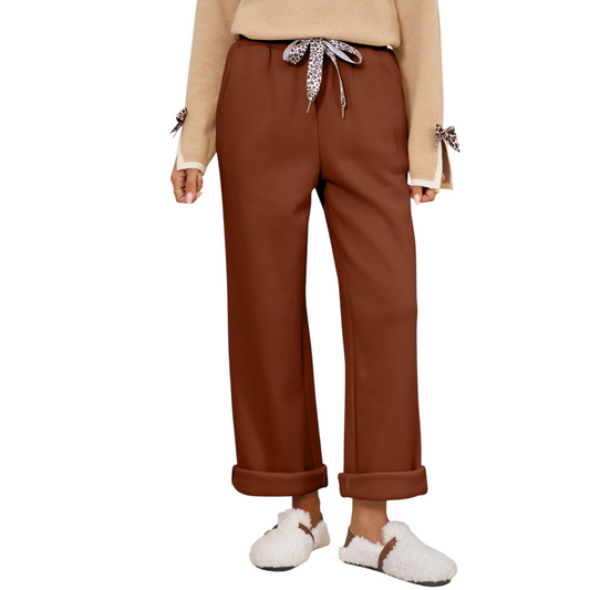 Brown pants worn by a person on a white background
