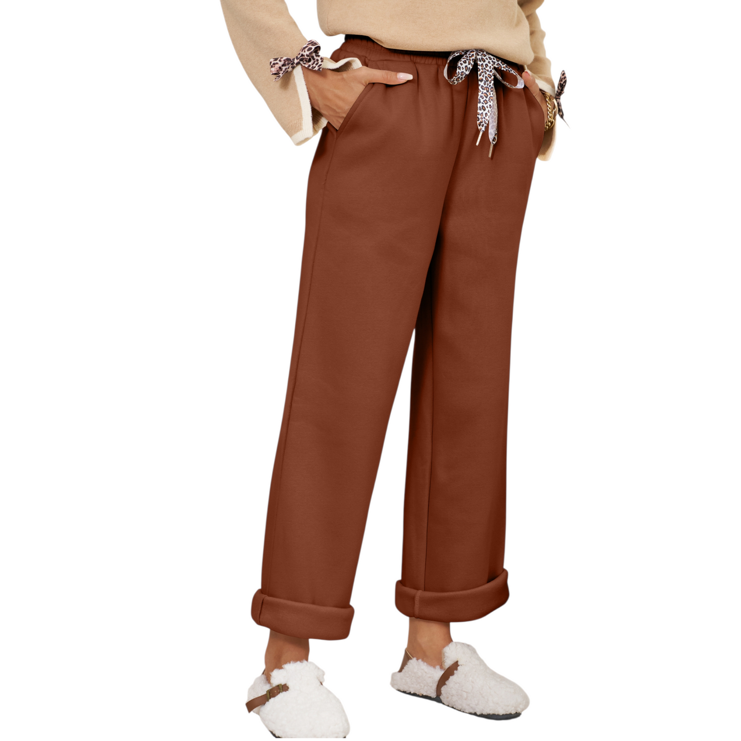 Brown pants worn by a person on a white background