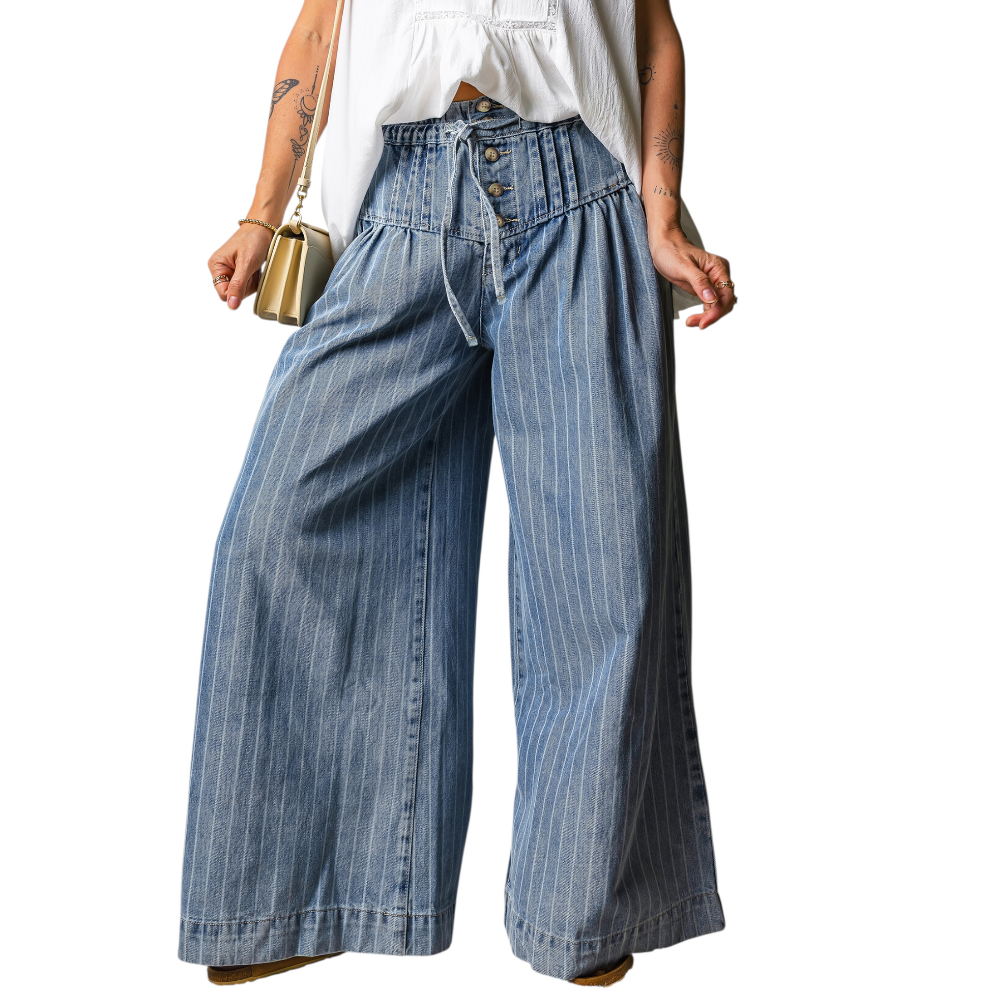 Person wearing wide-leg blue jeans with a white top on a white background