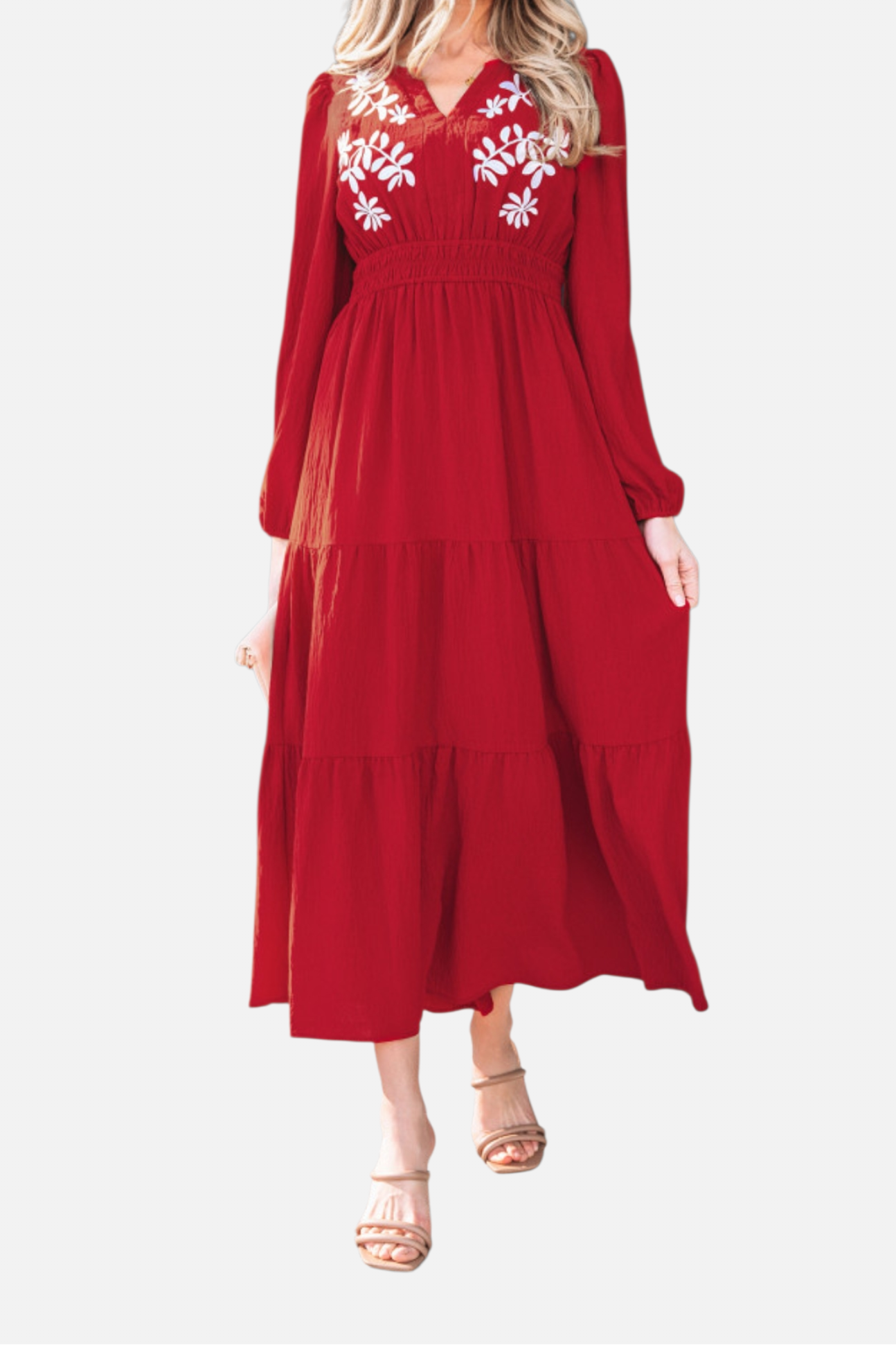 A walking shot of the tiered floral maxi dress demonstrating the lightweight, airy flow of the textured polyester fabric.