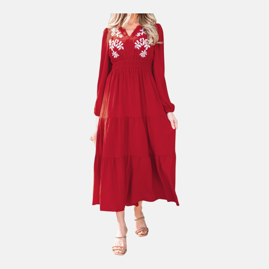 A walking shot of the tiered floral maxi dress demonstrating the lightweight, airy flow of the textured polyester fabric.