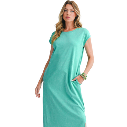 Woman wearing a teal dress on a white background