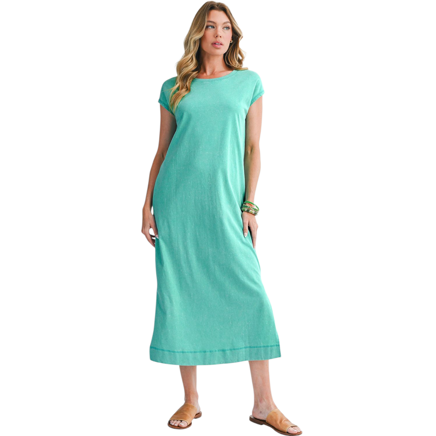 Woman wearing a teal dress on a white background