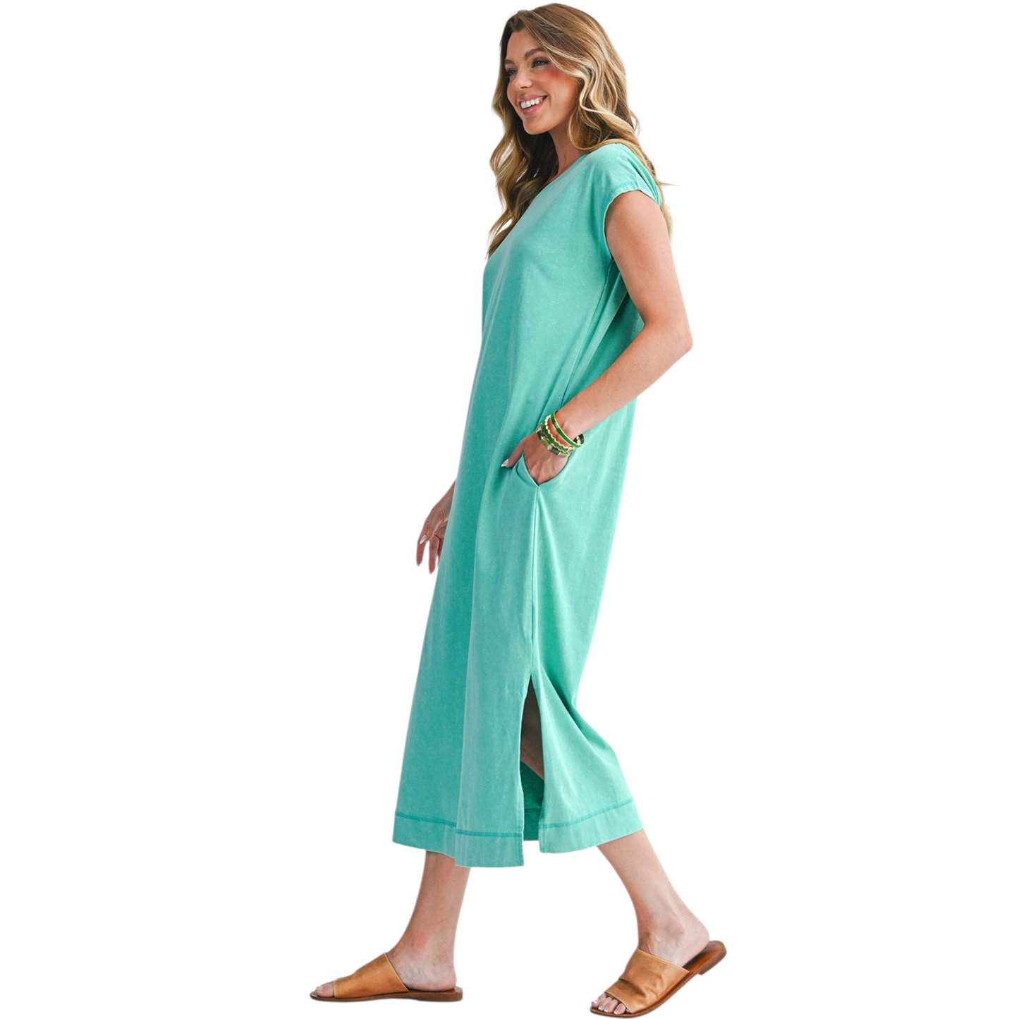 Woman wearing a teal dress on a white background