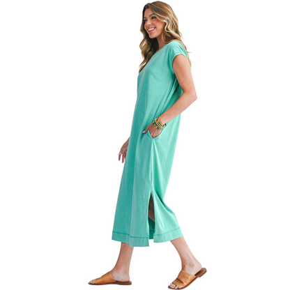 Woman wearing a teal dress on a white background