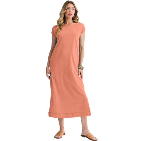 Woman wearing a peach-colored dress on a white background