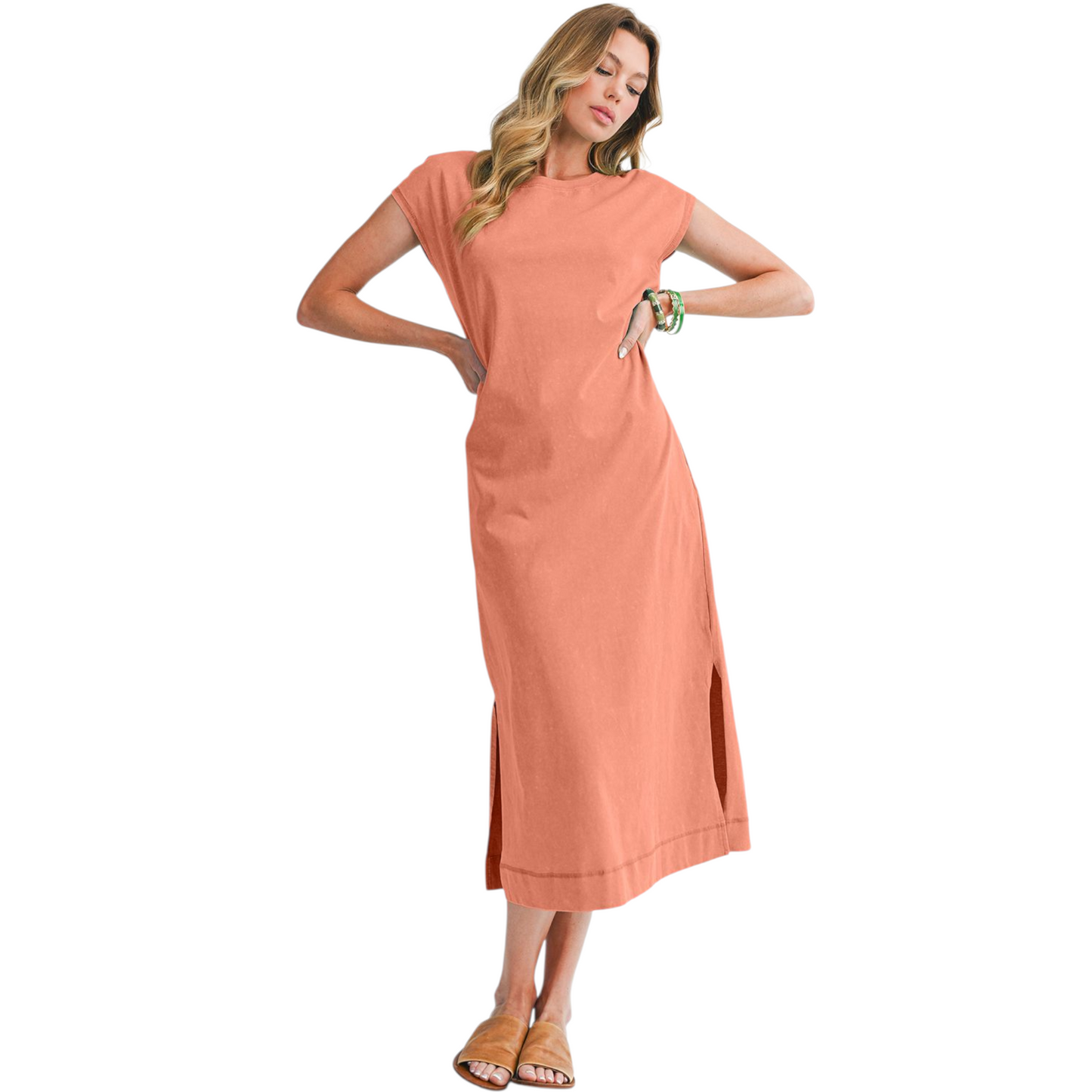 Woman wearing a peach-colored dress on a white background