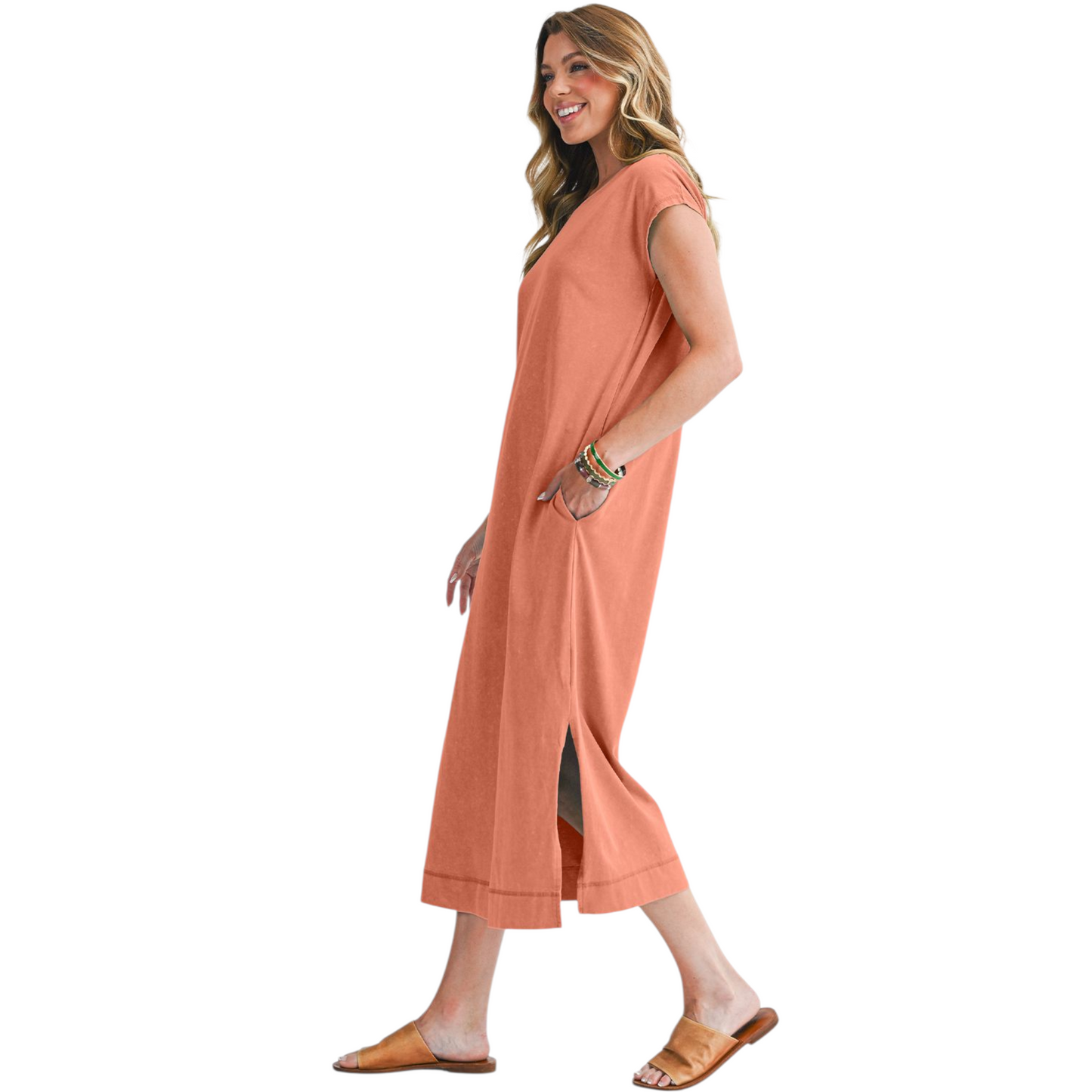 Woman wearing a peach-colored dress on a white background