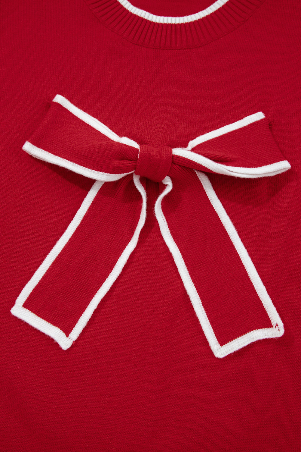 Red sweater with a large white bow detail