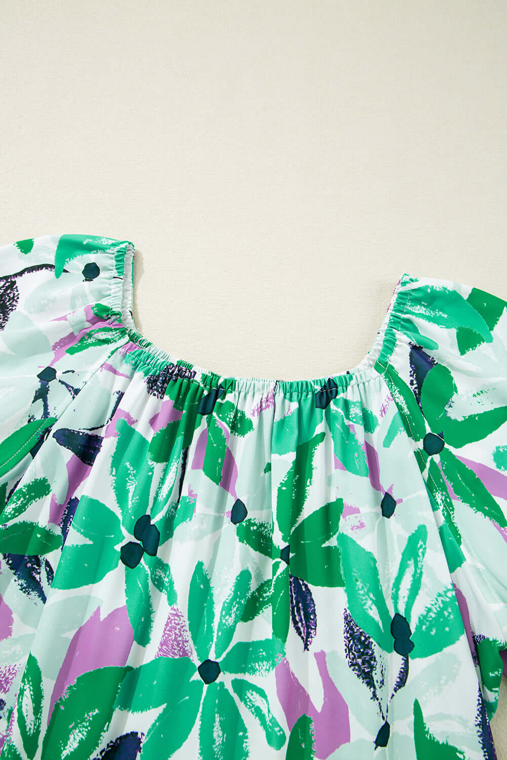 Stylish flowy dress with square neckline and short sleeves. Neckline view.