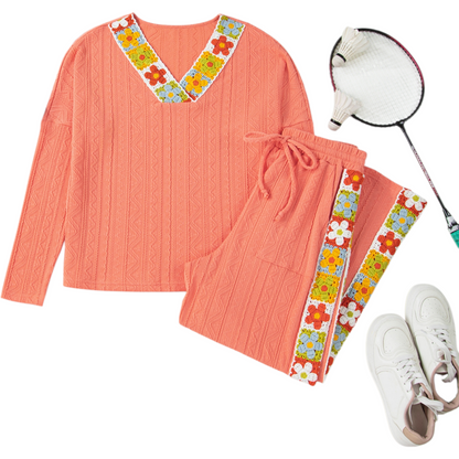 Coral outfit with floral accents, badminton racket, and shoes on a white background