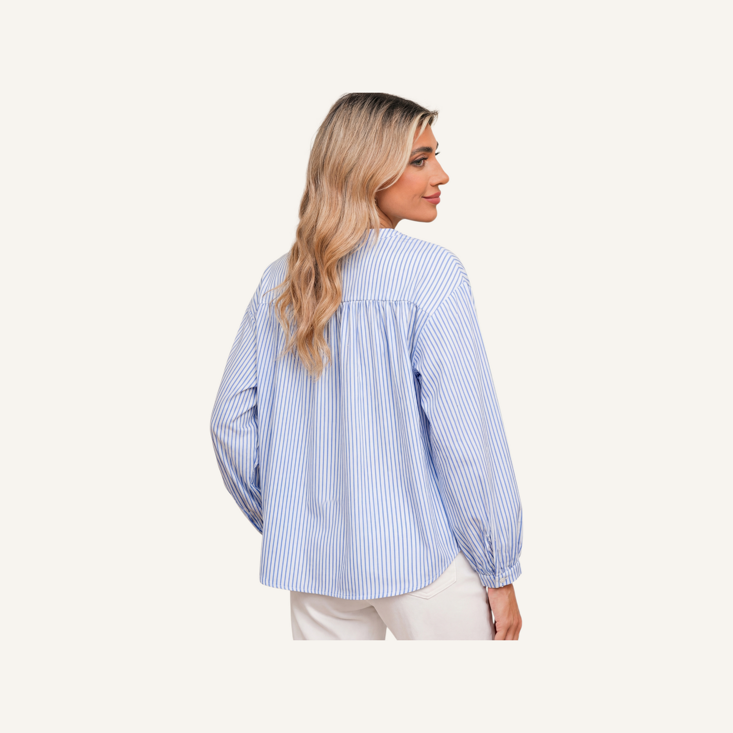 Rear view of a blue and white pinstriped tunic showcasing the relaxed, flowy fit and gathered yoke detail on a model.