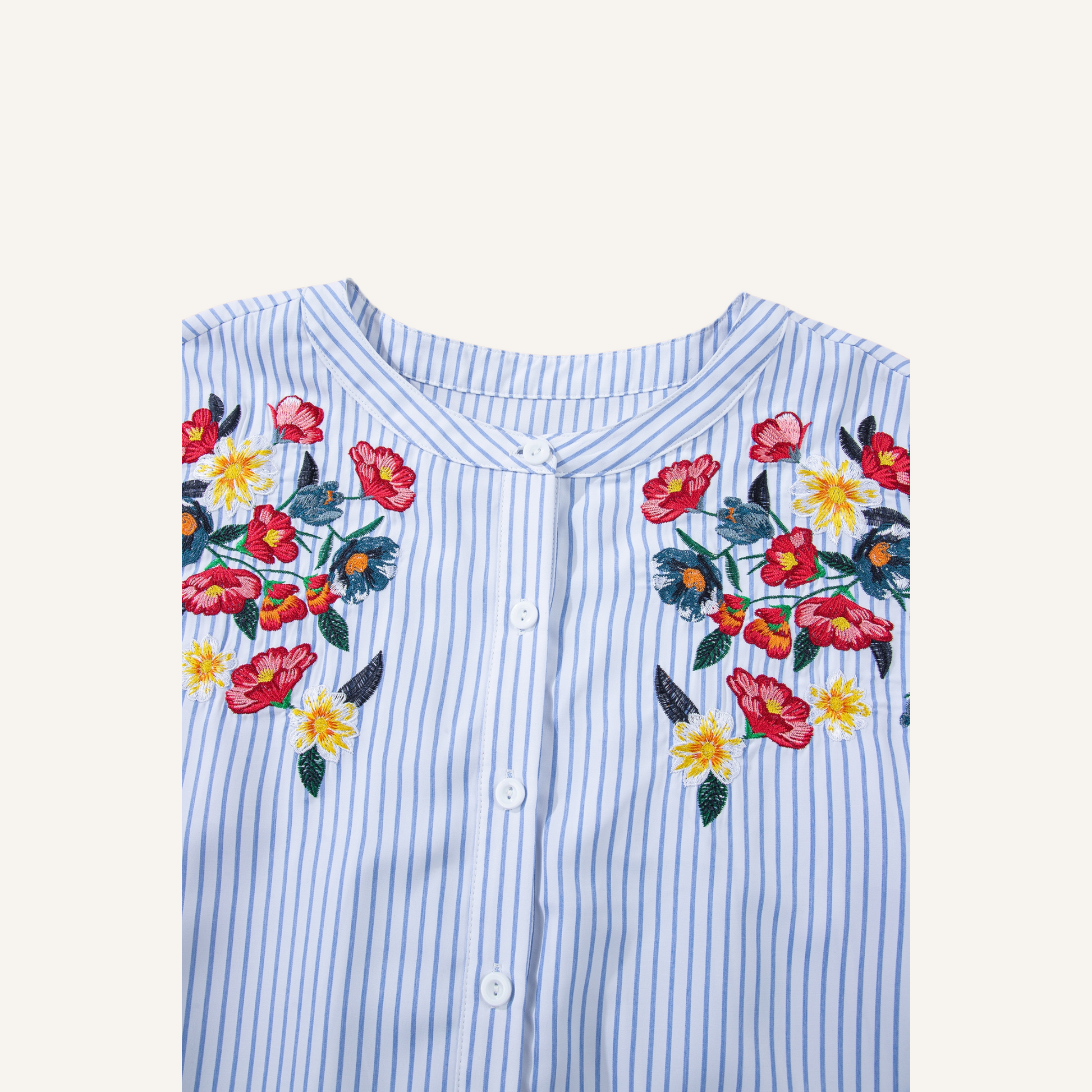 Close-up of intricate red and yellow floral embroidery on a blue pinstripe 100% polyester fabric.