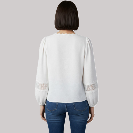 Rear view of an elegant white lace blouse showcasing a relaxed fit, gathered shoulders, and intricate floral lace inserts on the sleeves.
