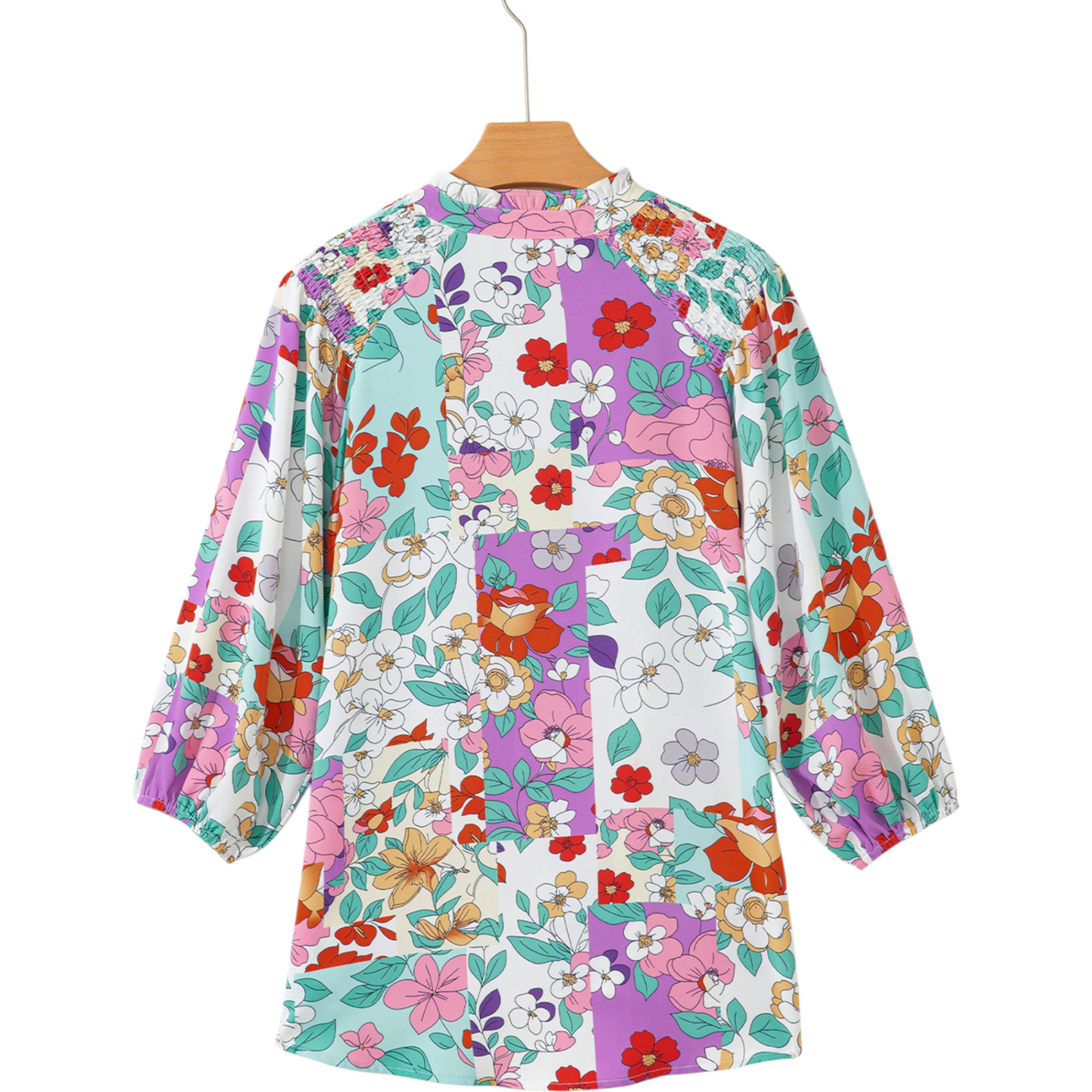Floral patterned shirt on a hanger with a white background
